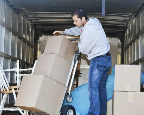Man in moving truck Mid adult man (30s) standing in moving truck, moving boxes.