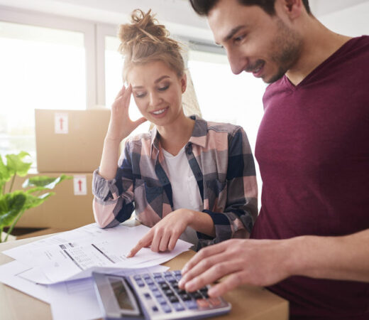 Worried couple examining expenses after moving into new house