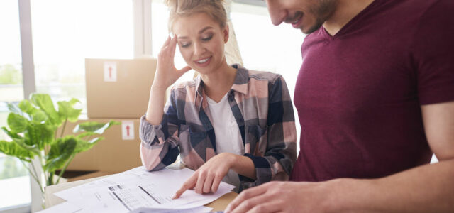 Worried couple examining expenses after moving into new house